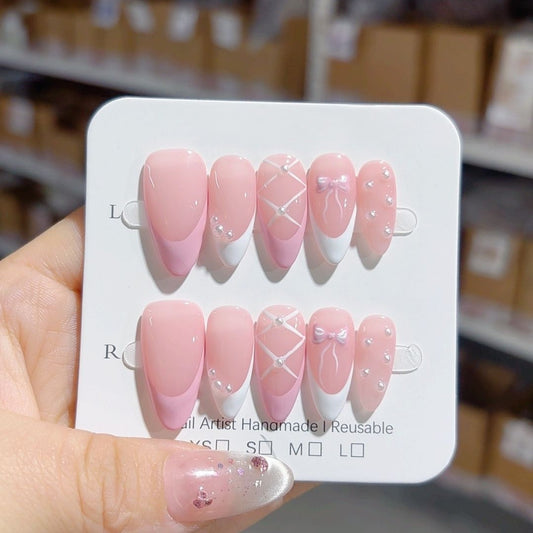 ongles rose et blanc, avec ruban et nœud papillon mignon et perle