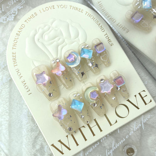 ongles long transparent, avec motifs 3d étoile et lune couleur pastel